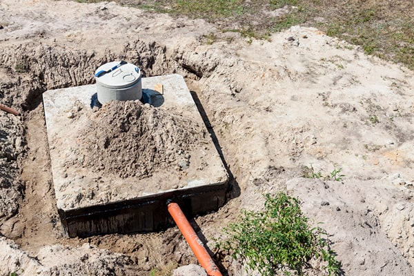 during septic tank pumping, a trained technician will use a vacuum truck to remove the sludge and scum from the tank